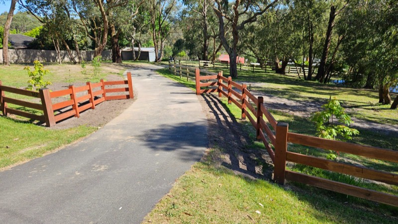 Two rail cypress boundary fence along a driveway at Beaconsfield Upper
