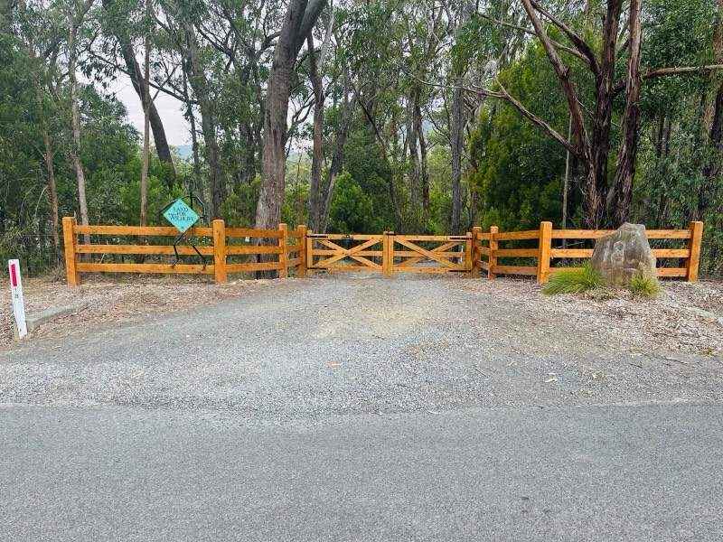 Cypress post and rail entrance with a farm gate at Healesville